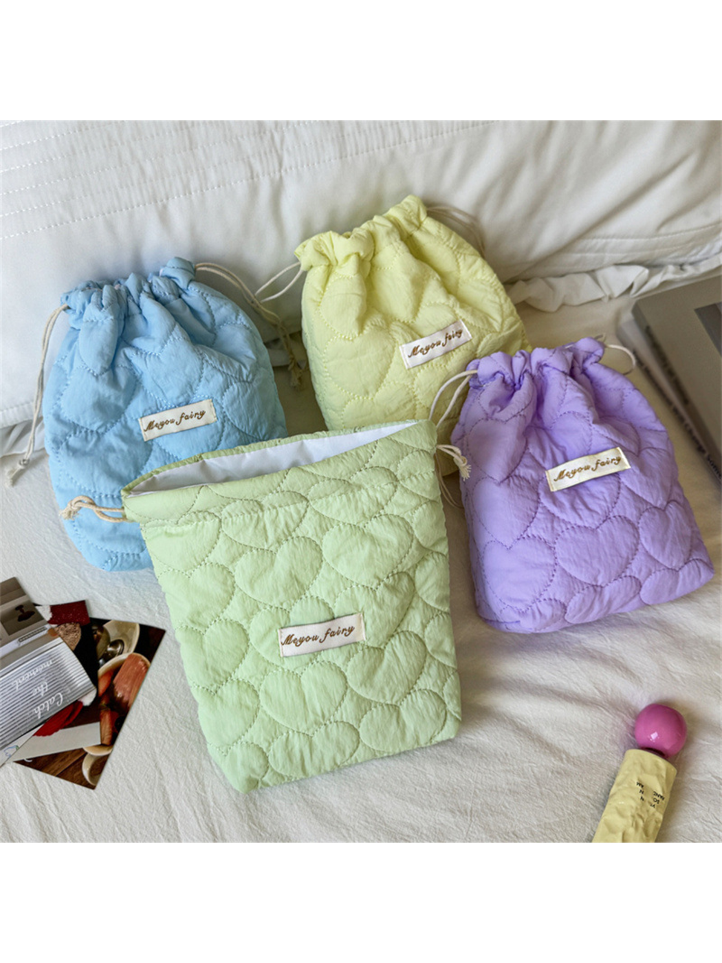 Open Mint pouch showing its white inner surface beside Blue, Yellow and Purple pouches