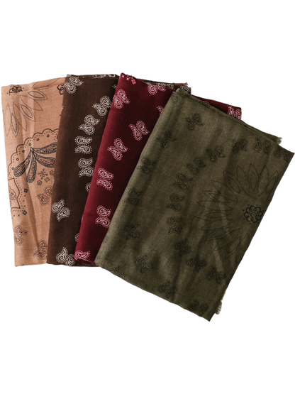 Several paisley scarves displayed together in overlapping folds