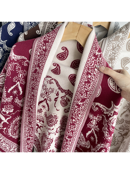 Navy paisley scarf draped on a hanger with ivory motifs and fringed edges