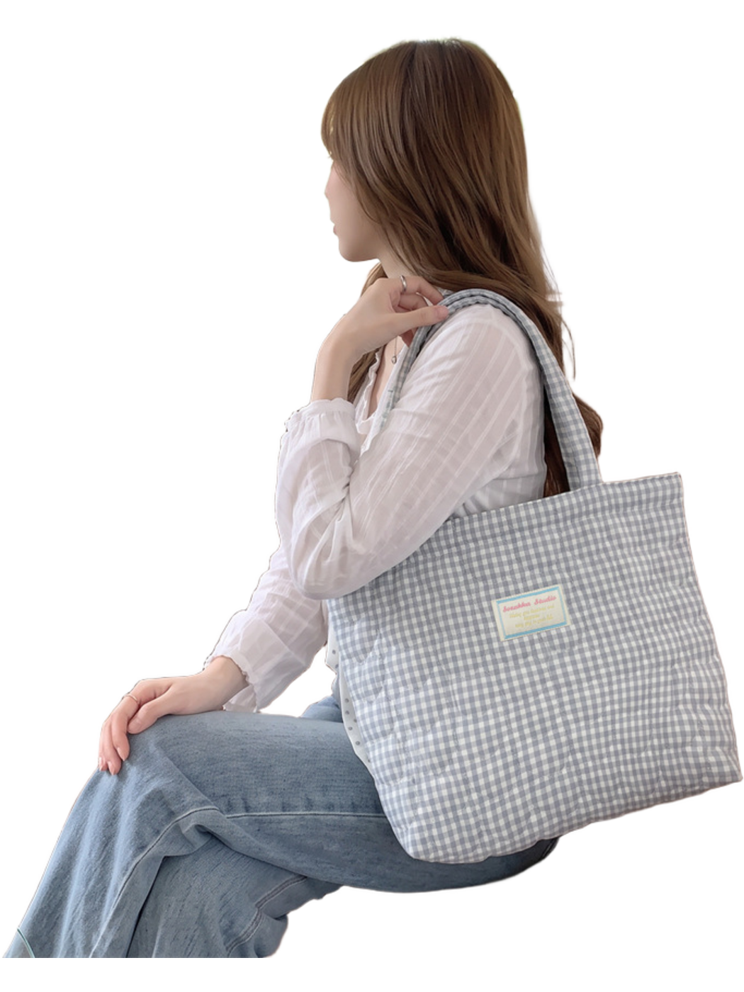 Light Blue gingham tote carried while seated, showing its drape