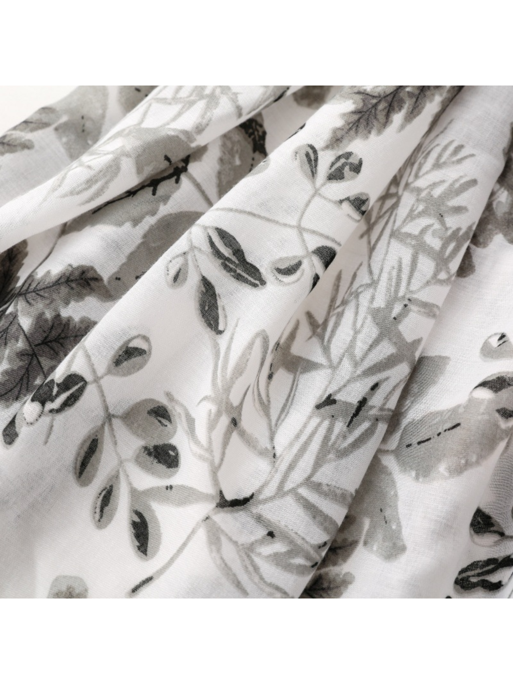 Close-up of Gray scarf showing botanical branches and assorted leaf motifs