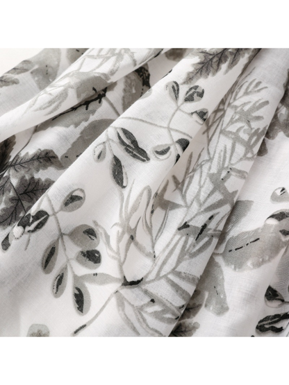Close-up of Gray scarf showing botanical branches and assorted leaf motifs