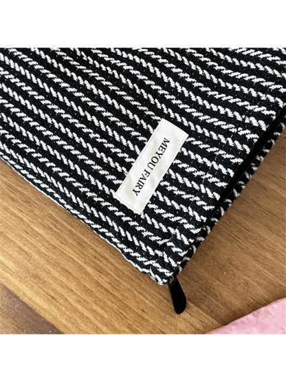 Close-up of the Black makeup pouch showing raised contrasting stitches and MEYOU FAIRY label