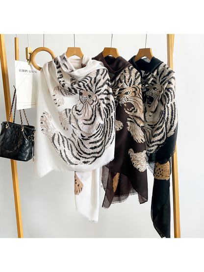 White, Brown and Black tiger-and-leopard scarves draped side by side on hangers