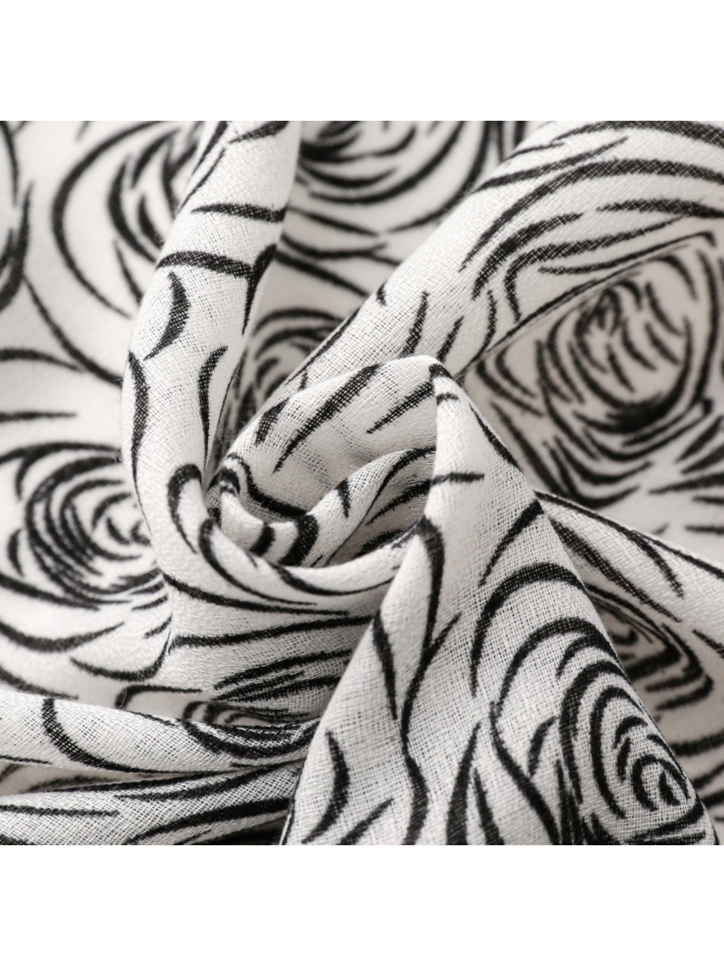 Close-up of rose-pattern scarf fabric gathered into folds