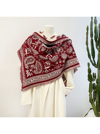 Red paisley scarf close-up showing ivory reverse, ornamental border and visible textile texture