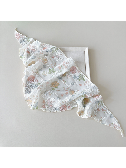 Floral scarf with white embroidery arranged in broad overlapping folds