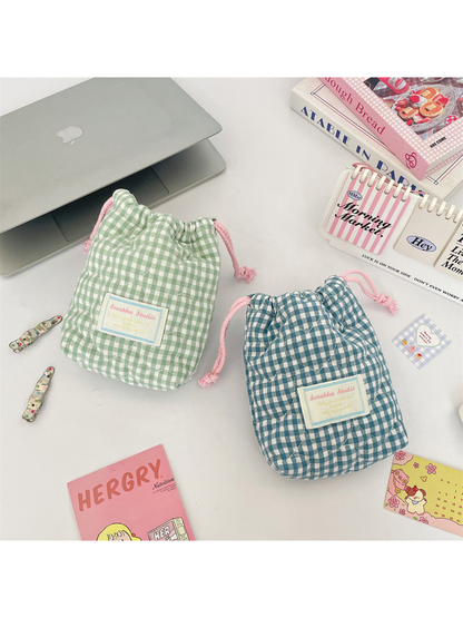 Green and Teal Blue gingham drawstring pouches displayed together with their quilted fronts visible