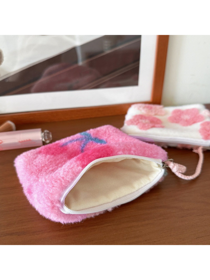Cherries makeup bag open to show its cream-colored interior lining