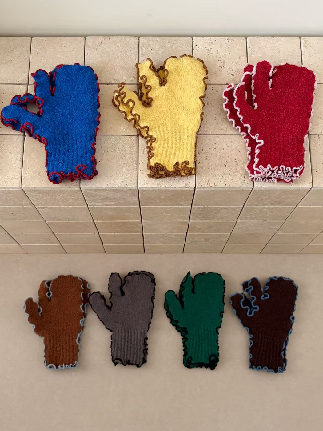 Blue, Yellow, Red, Caramel, Gray, Green and Coffee mittens displayed together