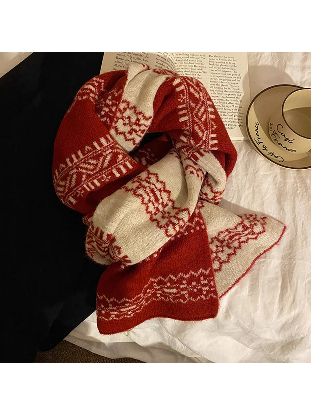 Red scarf arranged in a dimensional loop, showing ivory reverse panels and snowflake bands