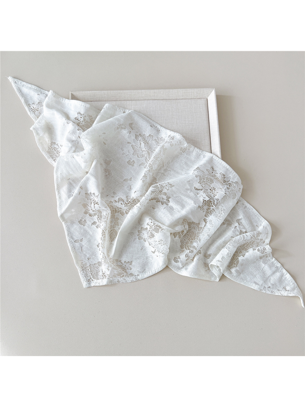 White scarf loosely spread to show floral lace panels and narrow finished edges