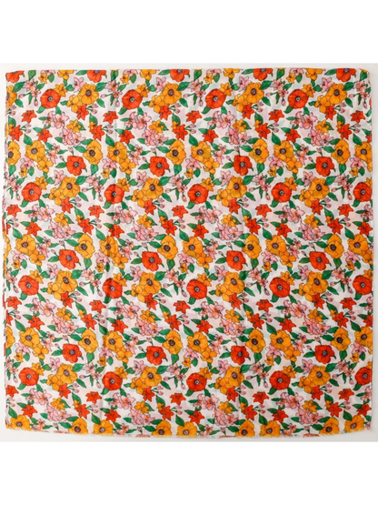 Floral scarf spread flat to show the allover pattern and fringed edges