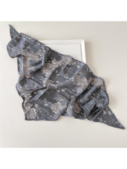 Gray scarf loosely spread to show sheer floral lace panels and finished edges