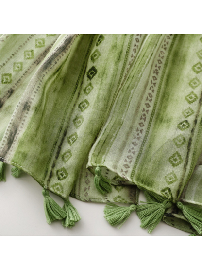 Close-up of green striped scarf ends with diamond motifs and matching tassels