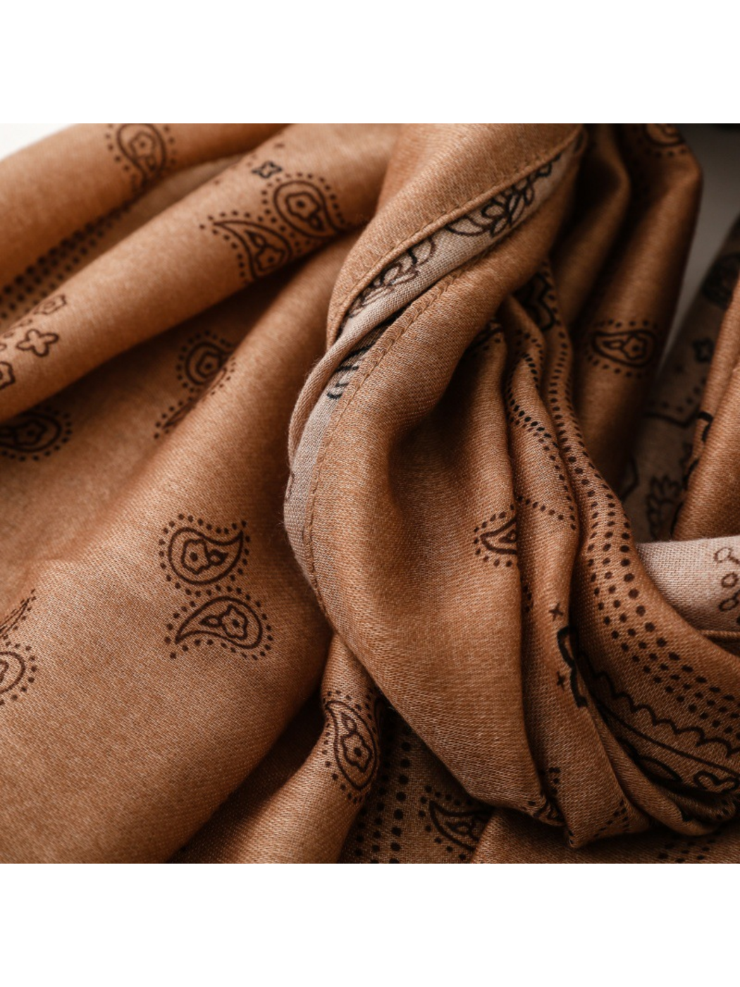 Close-up of scarf folds and dark paisley motifs
