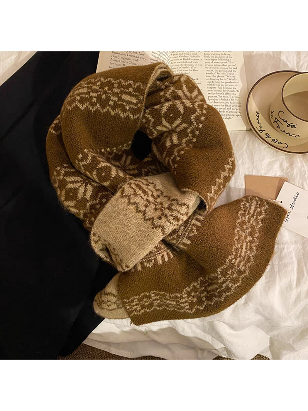 Brown scarf arranged in a loop with beige reverse panels and snowflake-pattern bands