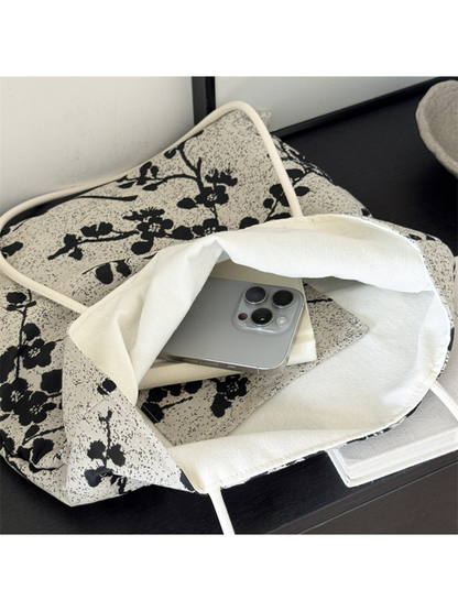 Close-up of the Black tote bag's wide opening and plain ivory interior lining