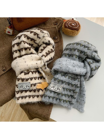 Ivory and Gray knit scarves displayed together with contrasting triangular bands and elephant patches