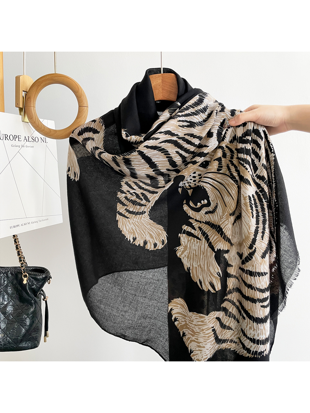 Close-up of the striped tiger motif and fringed edge on a Black scarf