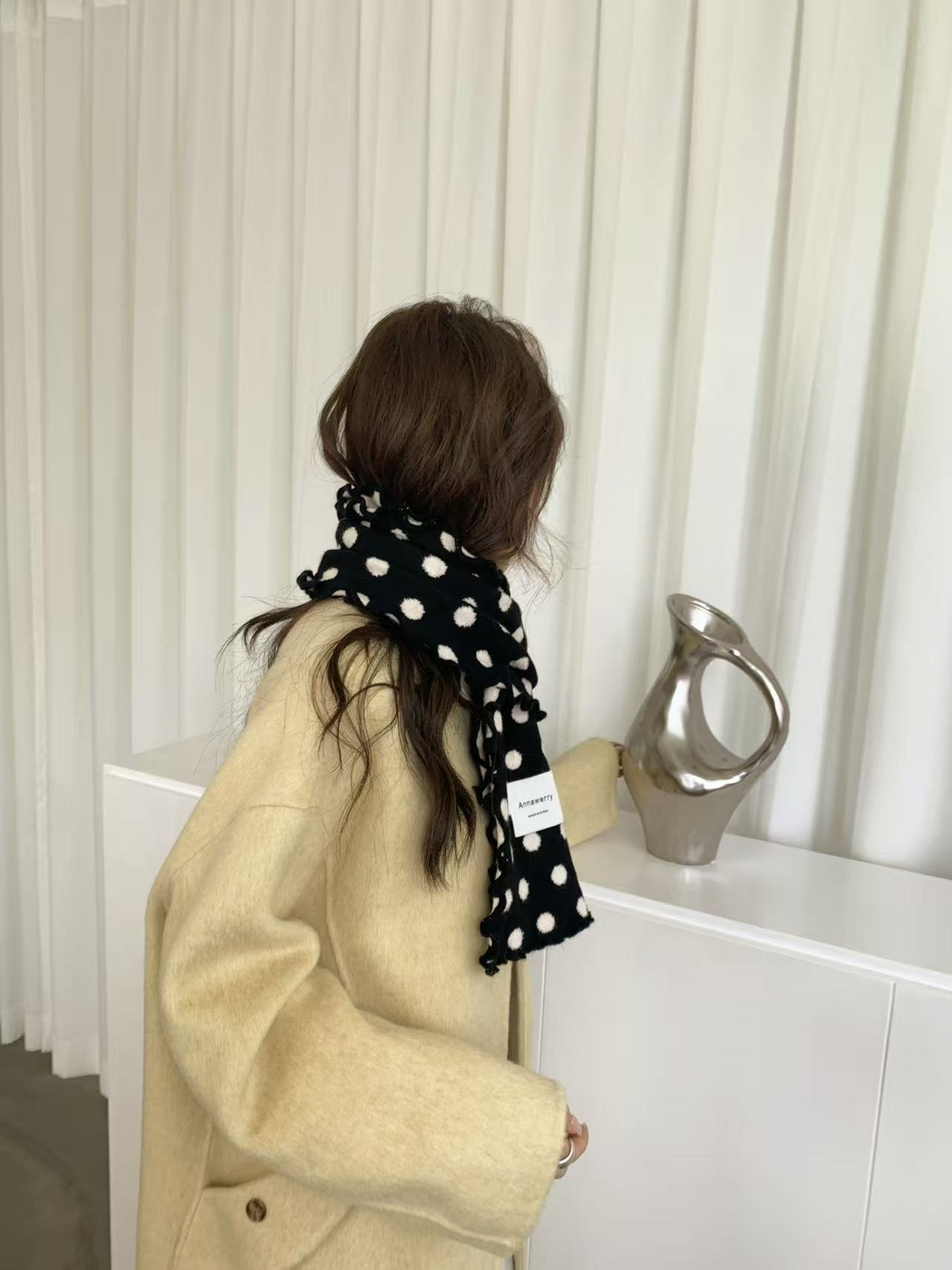 Black polka dot scarf wrapped around the neck, side and back view