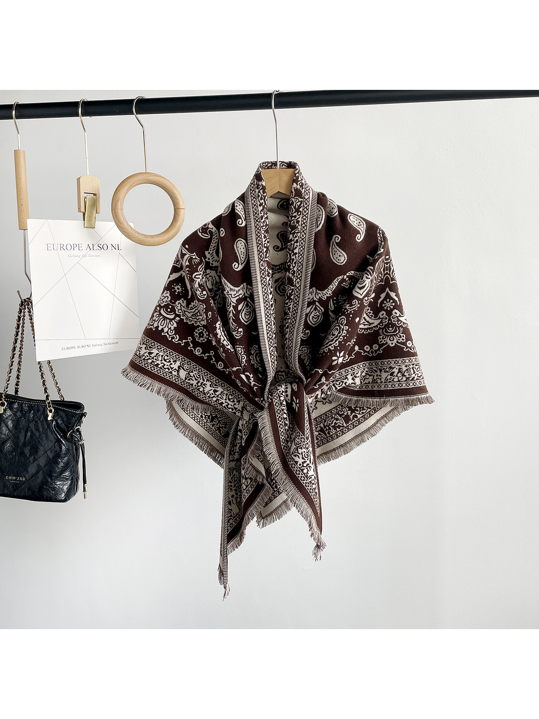 Gray paisley scarf arranged in a triangular front drape on a mannequin