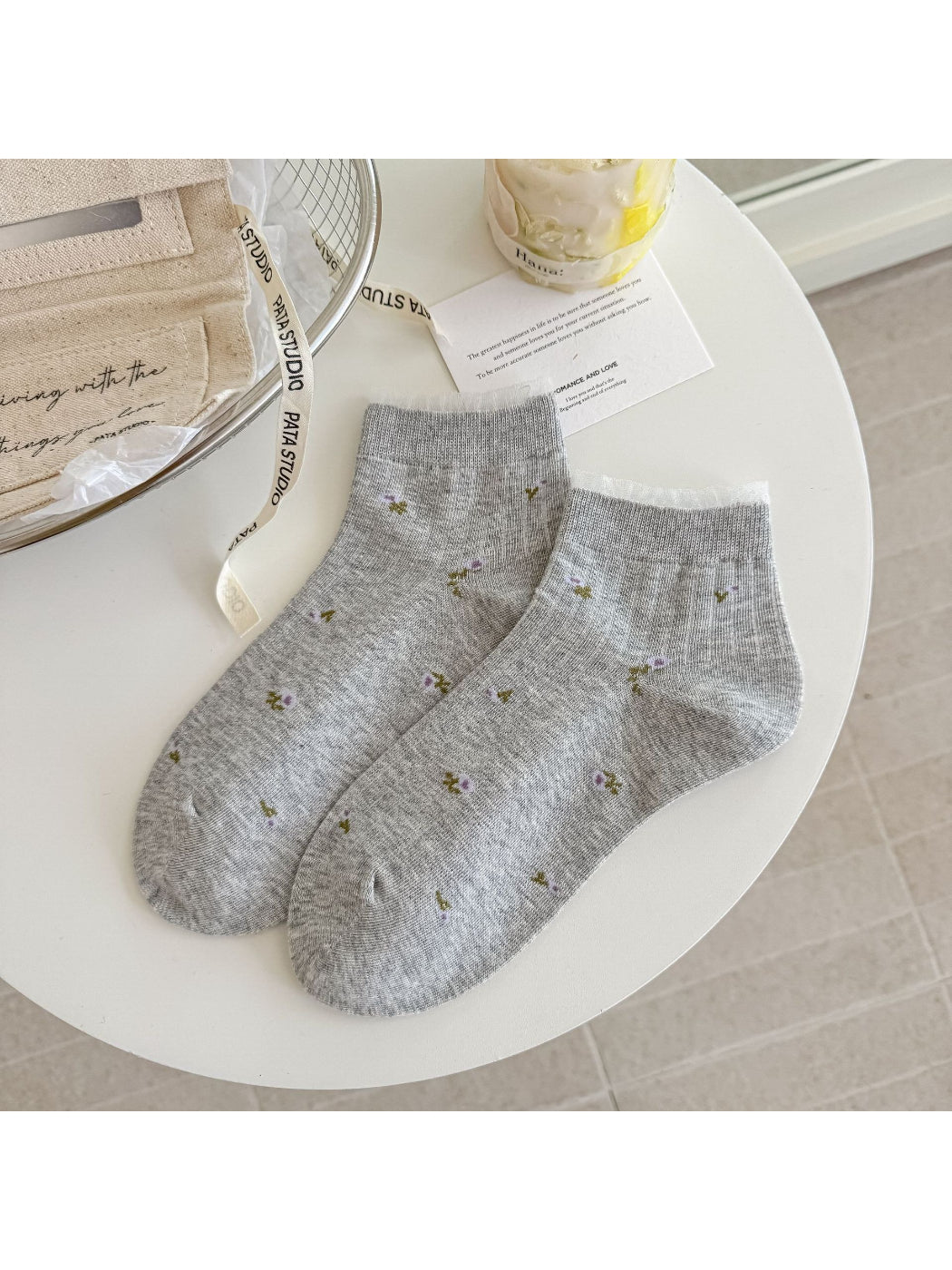 Model wearing Rufia soft floral lace trim ankle socks with white shoes