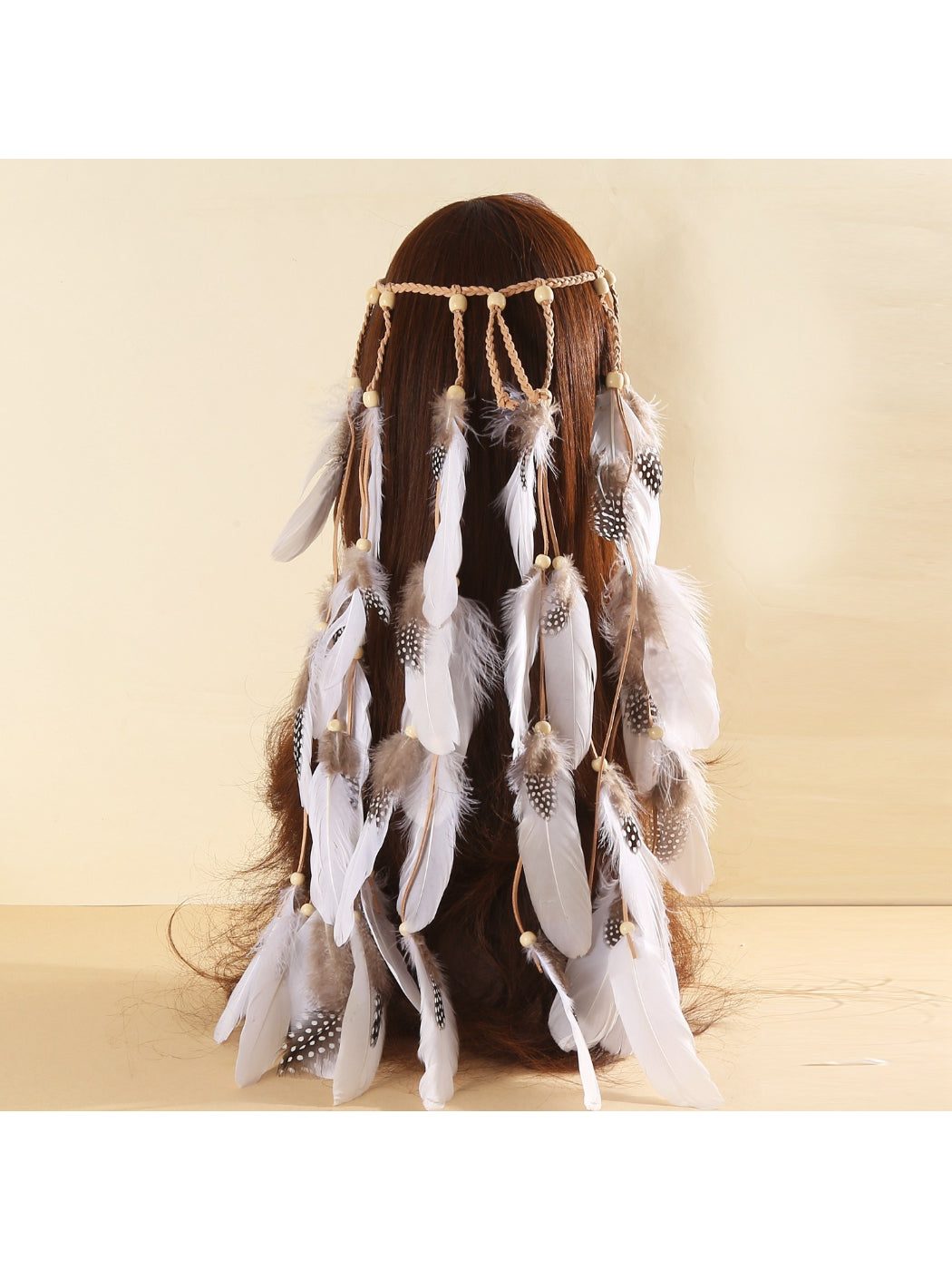 Close-up of Hairish feather and beaded hair headband showing detailed beadwork and feathers