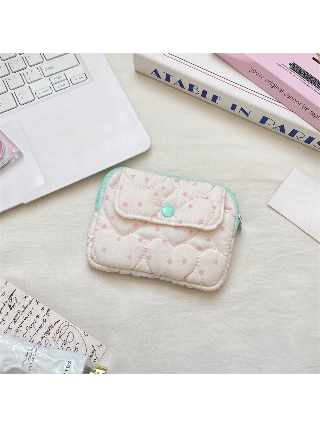Close-up of the quilted heart pattern on the pink mini card pouch by Cosbai