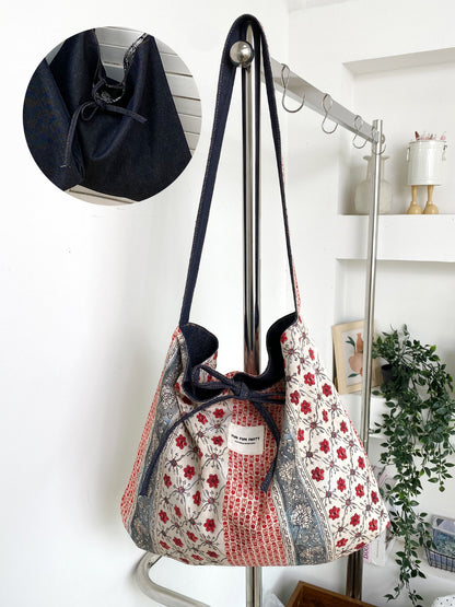 Cosbai patchwork shoulder bag worn over shoulder by model
