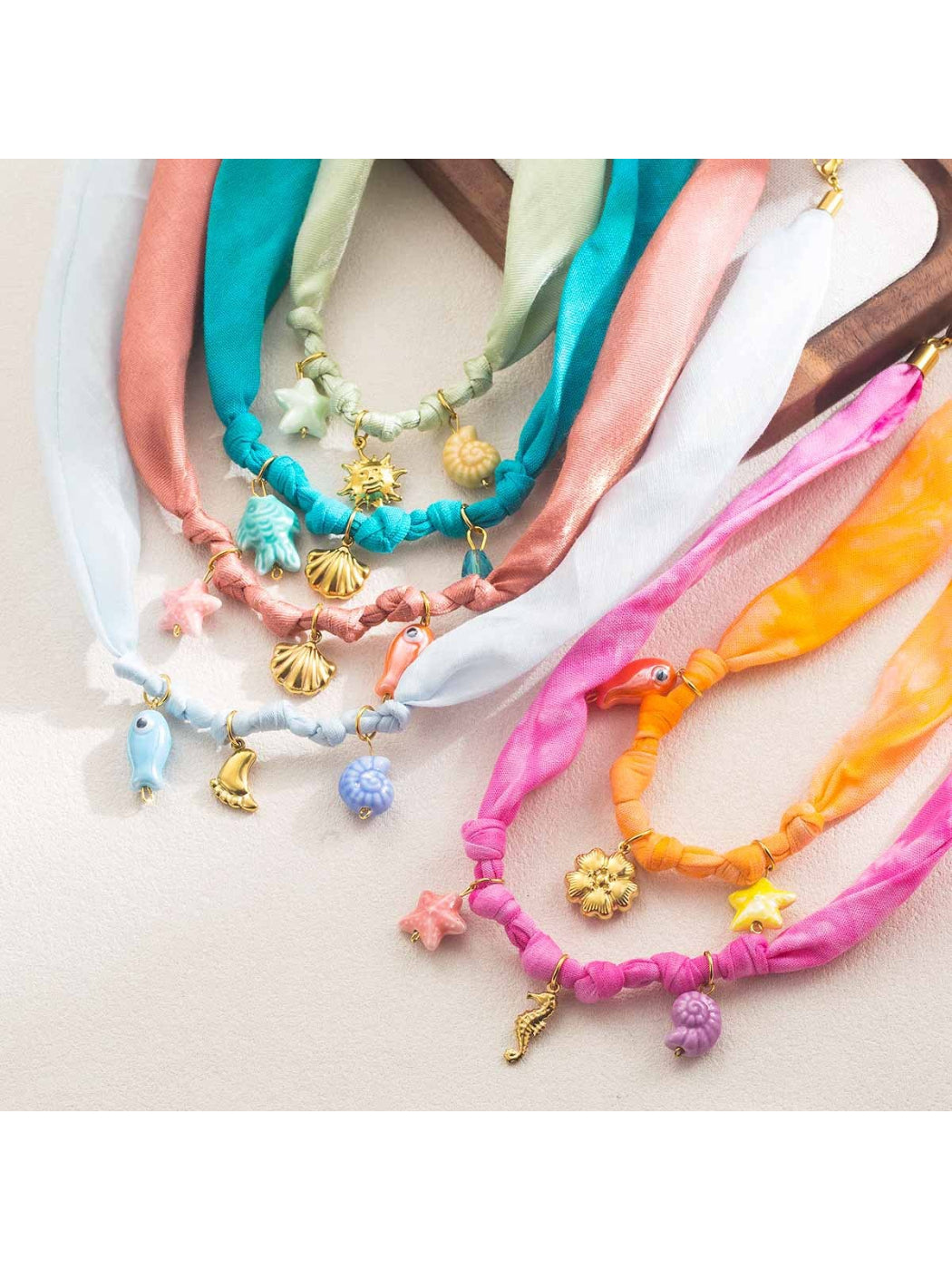 Close-up of clasp and charm details on Neckit Summer Charm fabric necklace