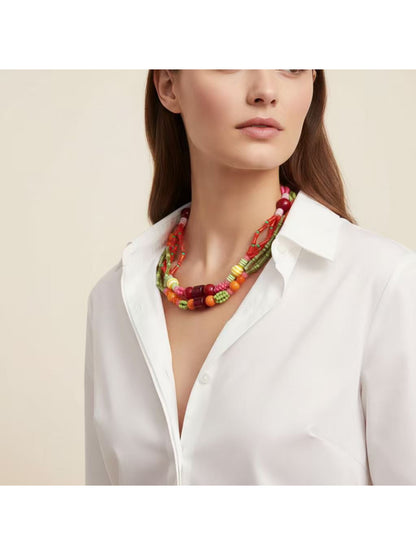 Colorful layered beaded necklace displayed on a white background