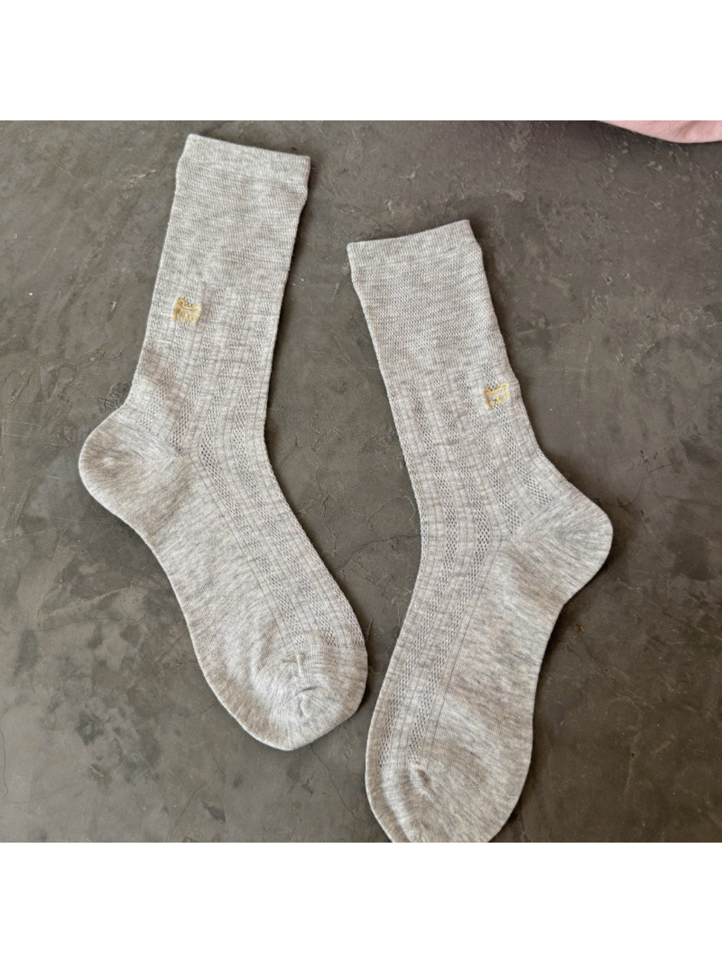 Side view of Rufia slouch sock featuring black cat embroidery