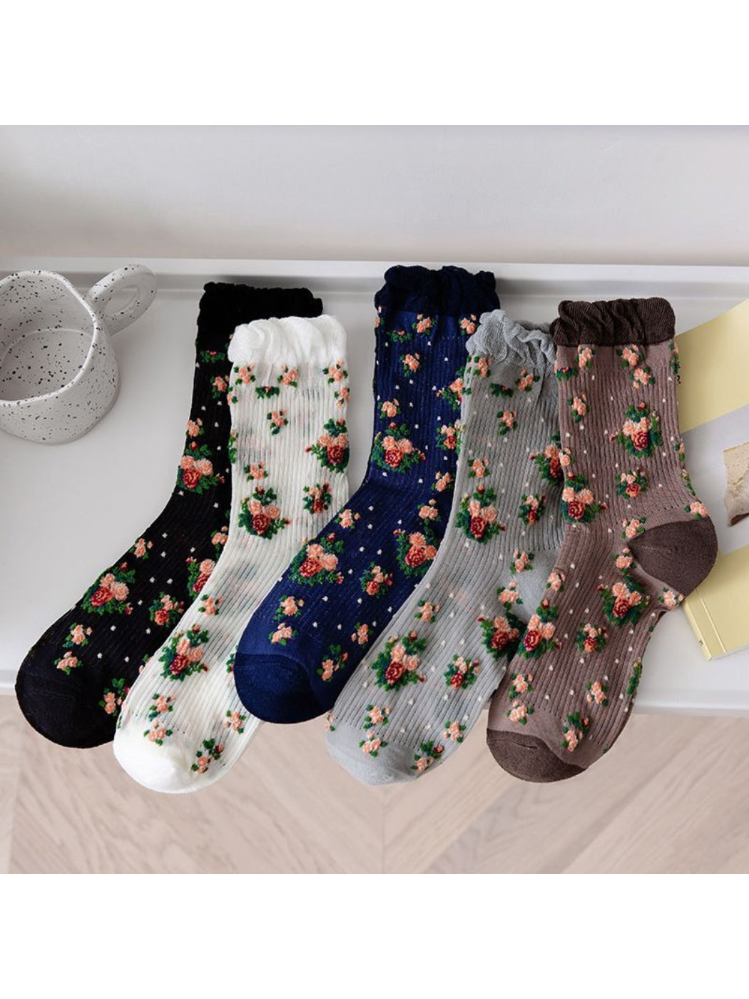 Pair of Rufia vintage rose floral crew socks laid flat showing full design