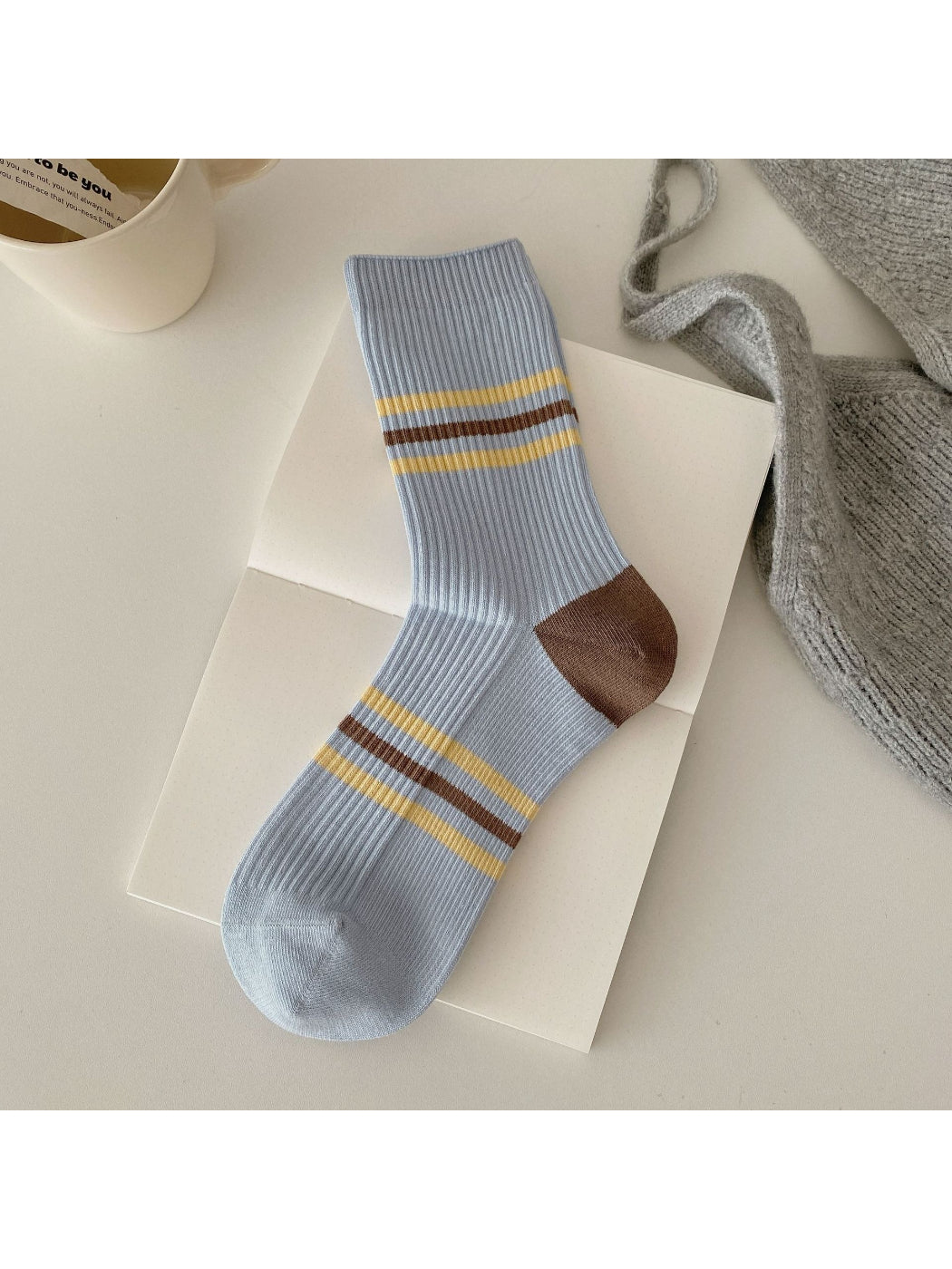 Flat lay of Rufia ribbed socks with emphasis on the soft fabric and colour block design