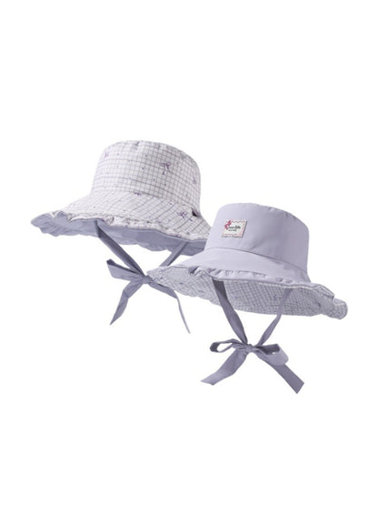 Model wearing Haila soft check bucket hat outdoors, styled with casual outfit