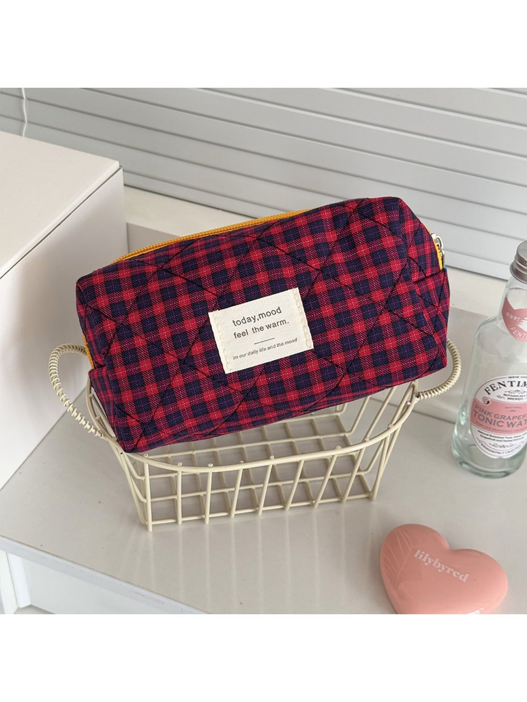 Cosbai colorful grid cosmetic pouch placed next to matching accessories
