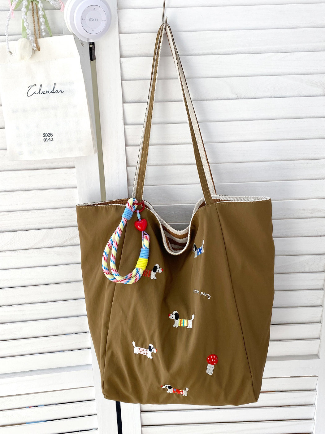 Cosbai tote bag placed on wooden surface with lighting