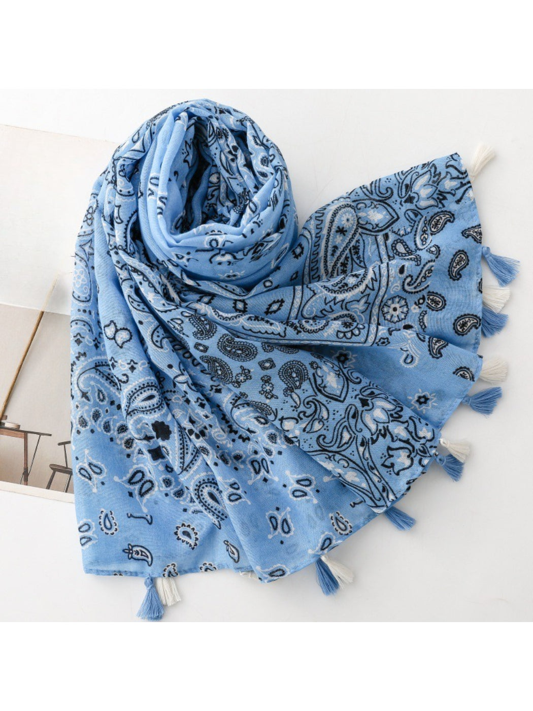 Close-up of Scarvii wrap fabric highlighting intricate paisley and patchwork design with tassels