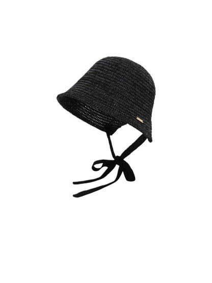 Side view of Haila woven straw bucket hat highlighting the ribbon tie detail