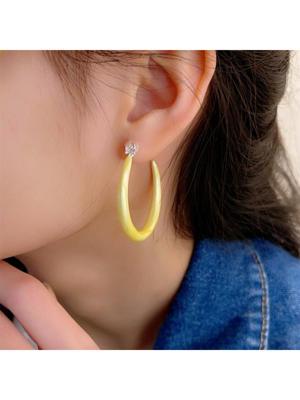 Close-up of glossy color hoop earrings showing smooth finish