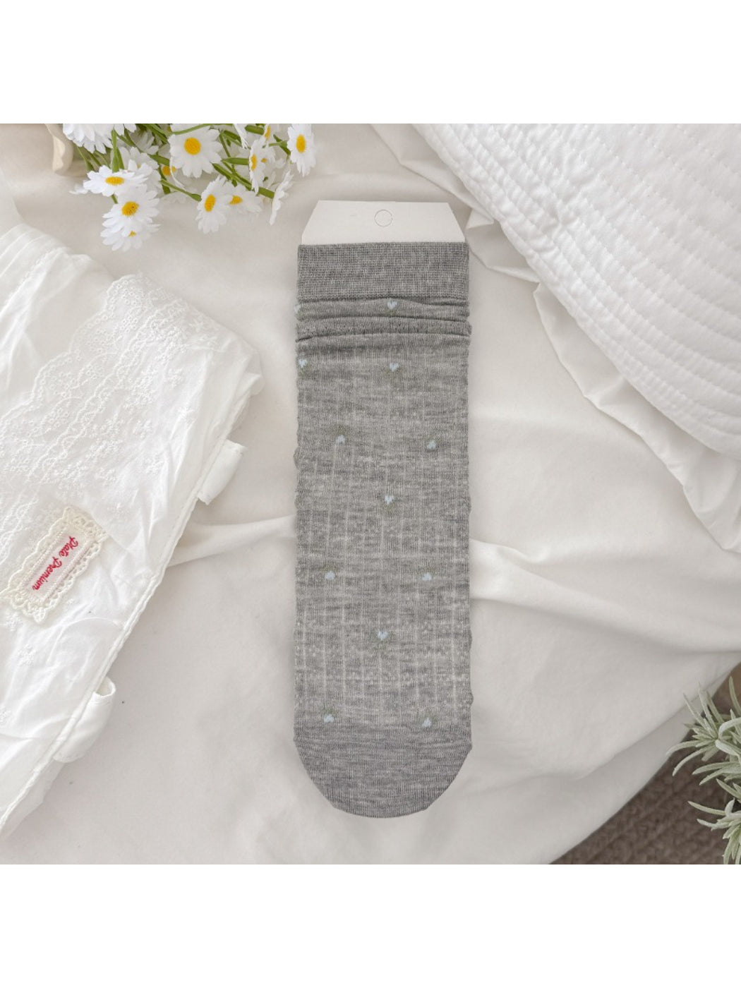 Rufia socks displayed on a wooden surface emphasizing floral print