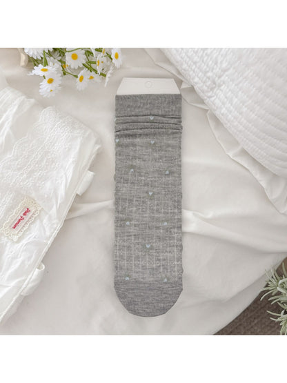 Rufia socks displayed on a wooden surface emphasizing floral print