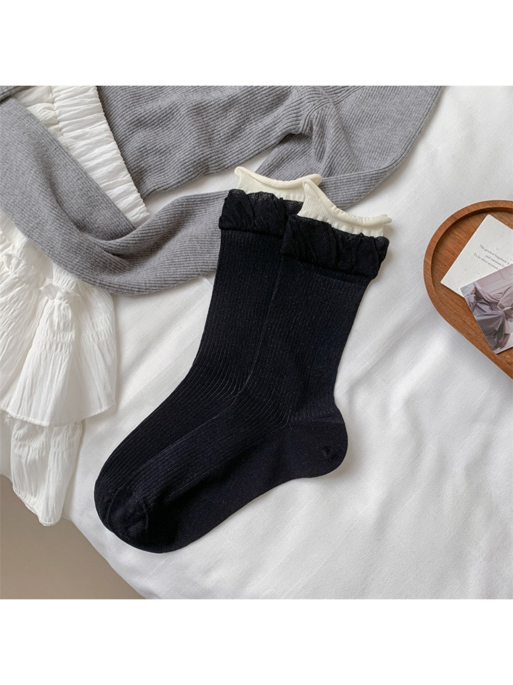 Side view of Rufia beige ribbed crew socks showing ruffle trim at the cuff
