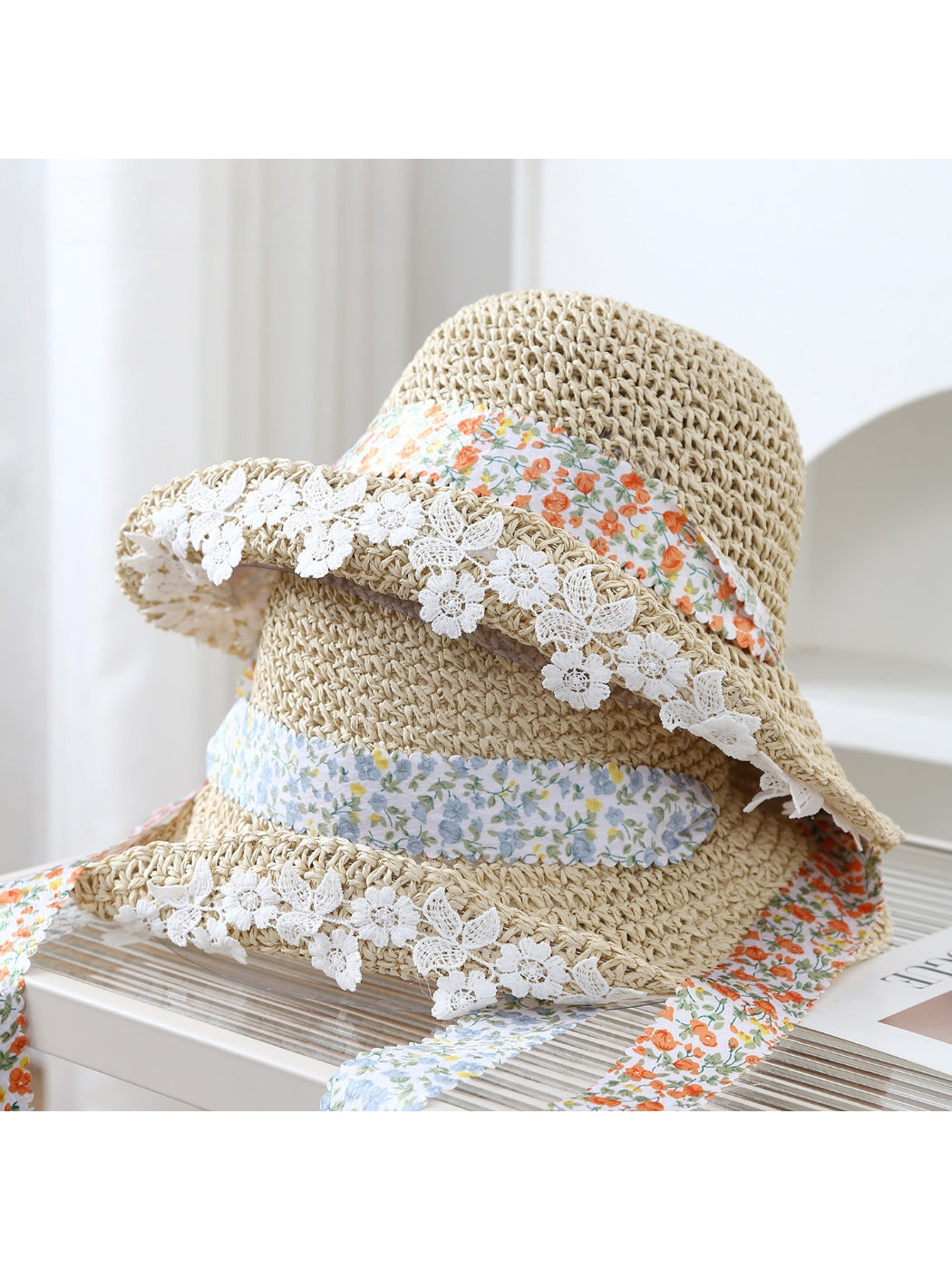 Haila bucket hat with lace trim and floral band displayed on a white background