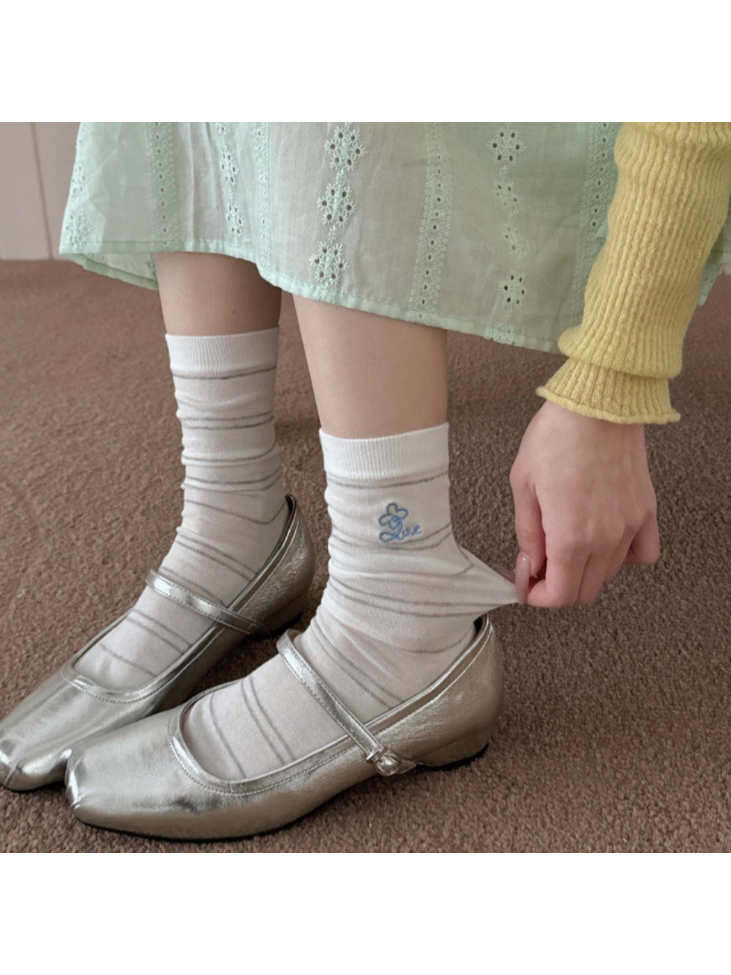 Pair of Rufia pastel stripe knit socks laid flat on white background