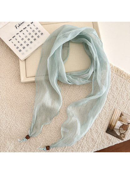 Beige sheer skinny scarf with fine pleats displayed flat