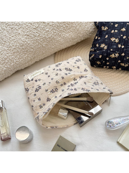 Cosbai vintage floral makeup storage pouch with zipper pull visible on top edge