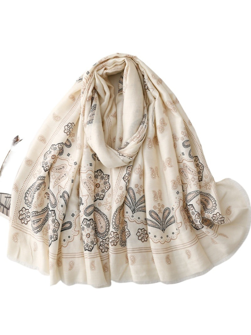 Soft boho paisley scarf casually draped over a chair in natural light