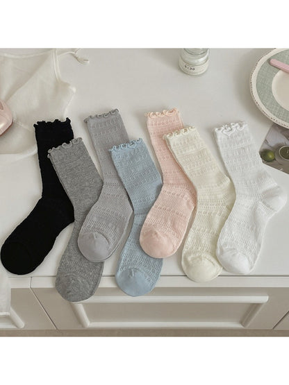Pair of Rufia Sweet Ruffle Edge Socks in soft pastel pink displayed flat